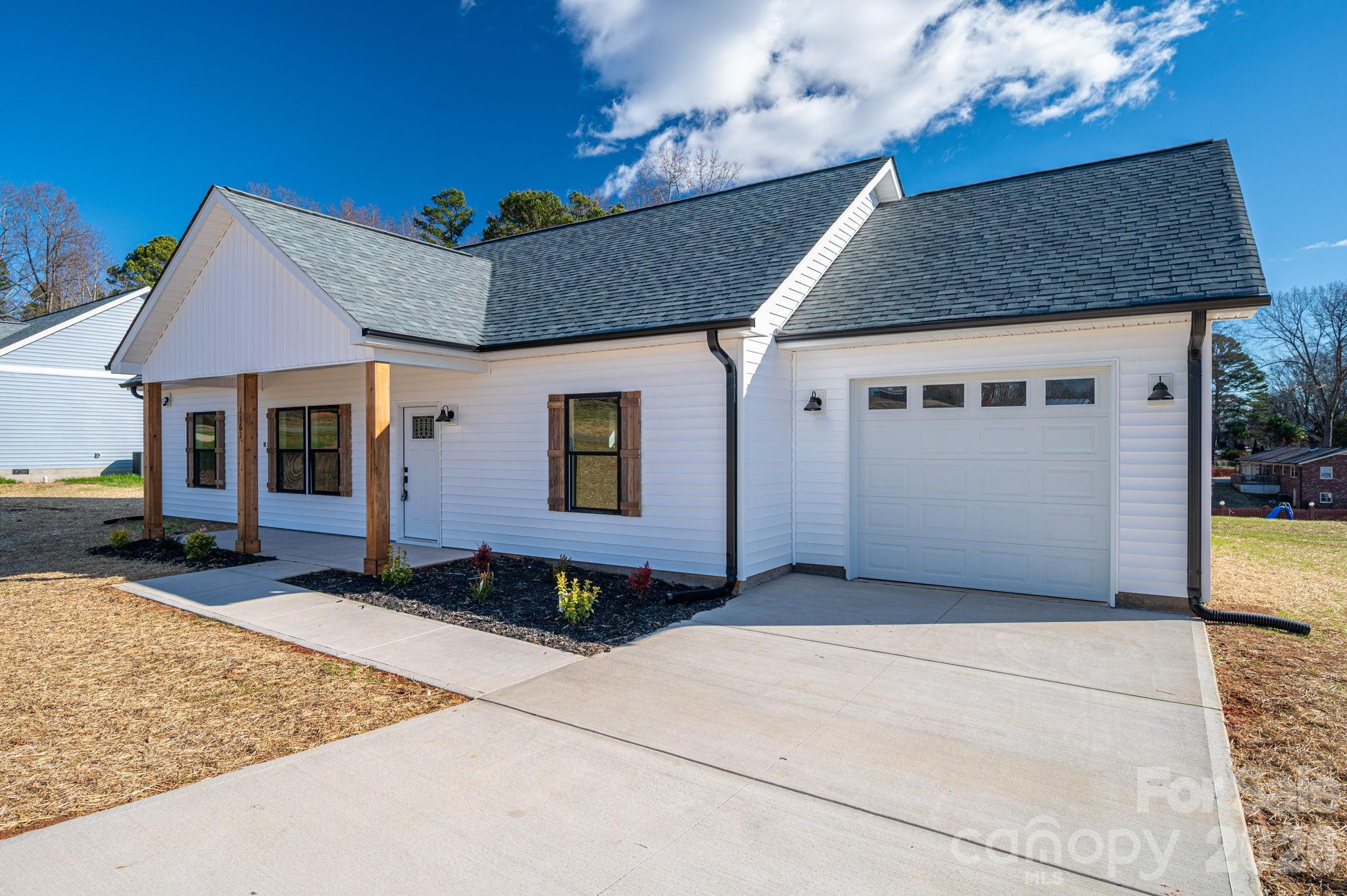 1161 13th Street Southwest Hickory, NC 28602 - Photo 2 of 27 a front view of a house with a garden
