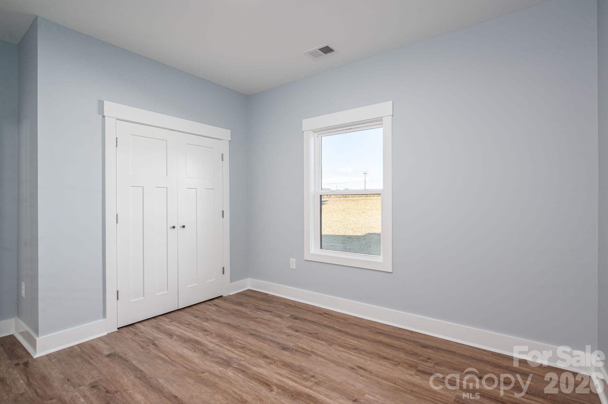 1161 13th Street Southwest Hickory, NC 28602 - Photo 21 of 27 a view of an empty room with wooden floor and a window