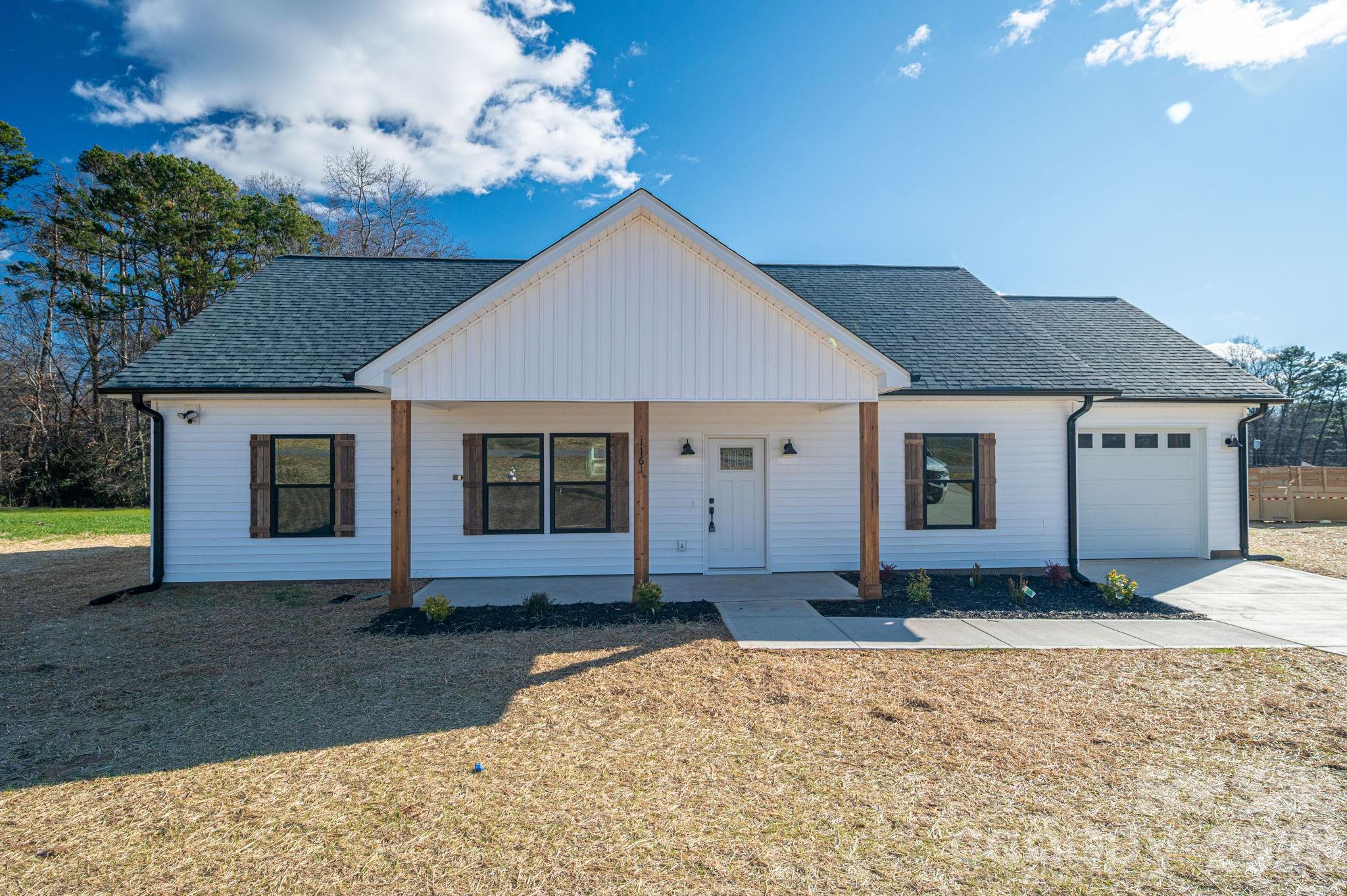 1161 13th Street Southwest Hickory, NC 28602 - Photo 25 of 27 a front view of a house with a yard and garage