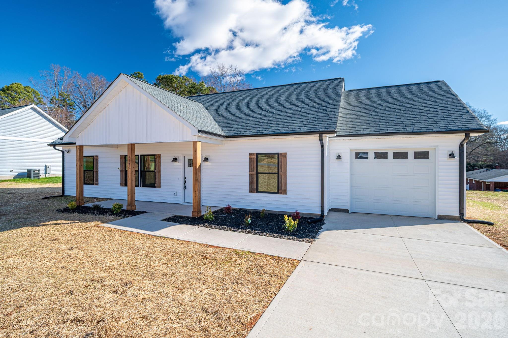 1161 13th Street Southwest Hickory, NC 28602 - Photo 27 of 27 a front view of a house with a garden and seating space