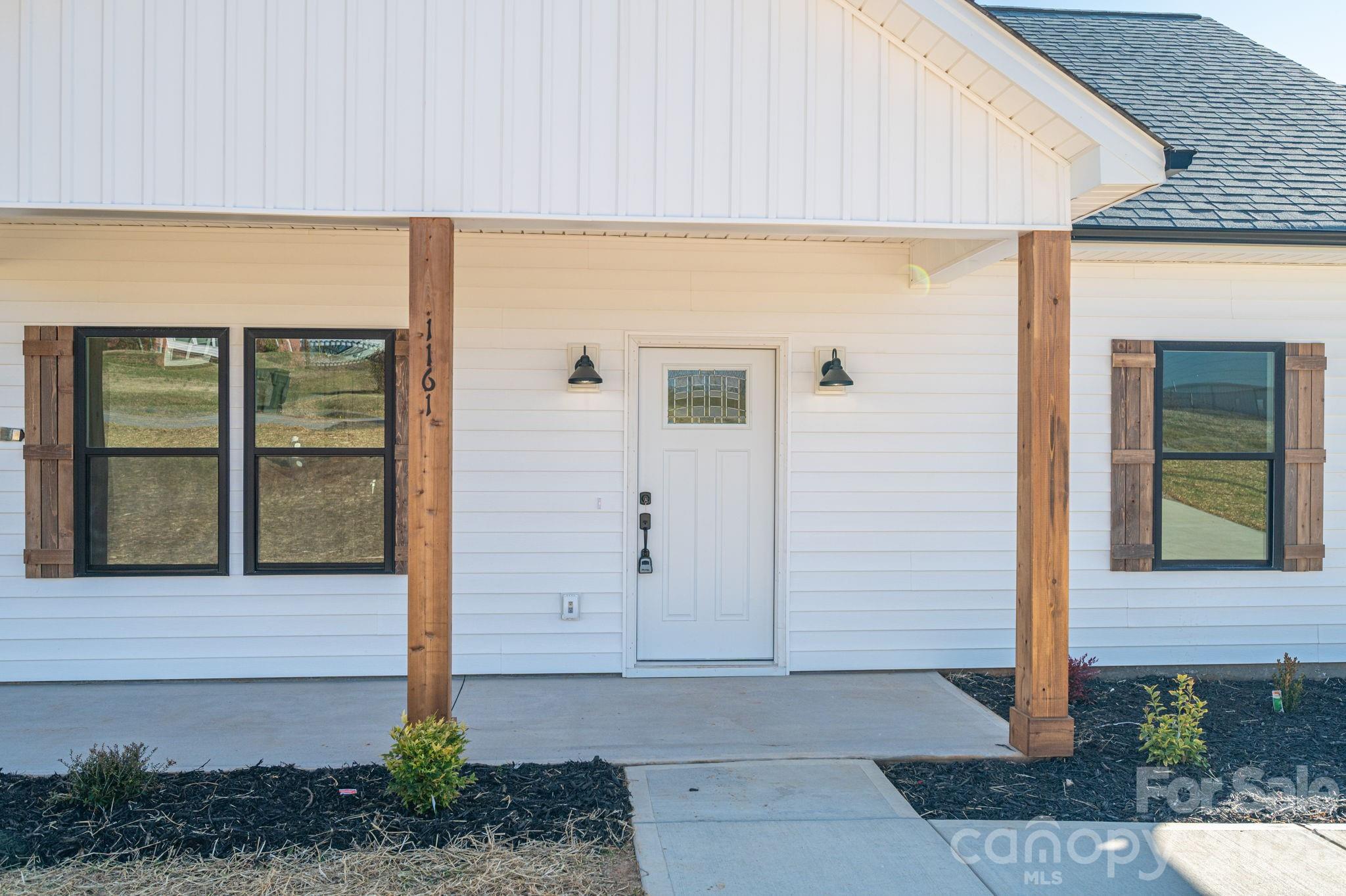 1161 13th Street Southwest Hickory, NC 28602 - Photo 3 of 27 a front view of a house with a plants