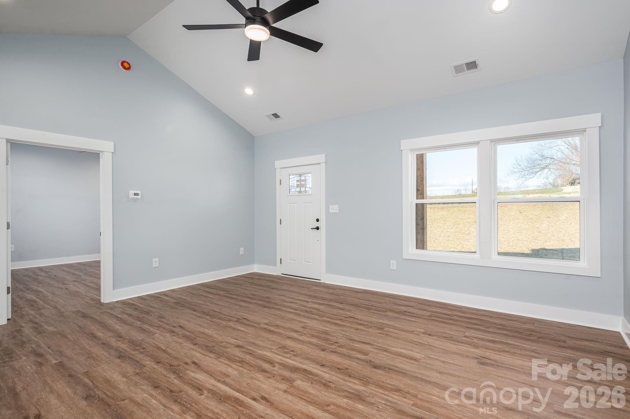 1161 13th Street Southwest Hickory, NC 28602 - Photo 5 of 27 a view of an empty room with wooden floor and a window