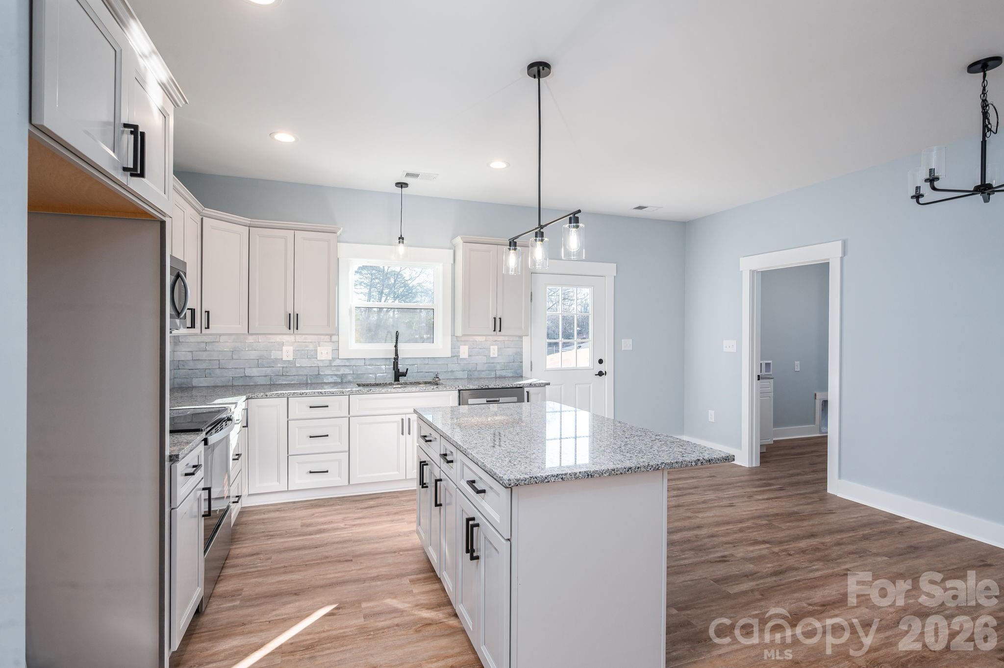 1161 13th Street Southwest Hickory, NC 28602 - Photo 10 of 27 a large kitchen with kitchen island a sink stainless steel appliances and cabinets