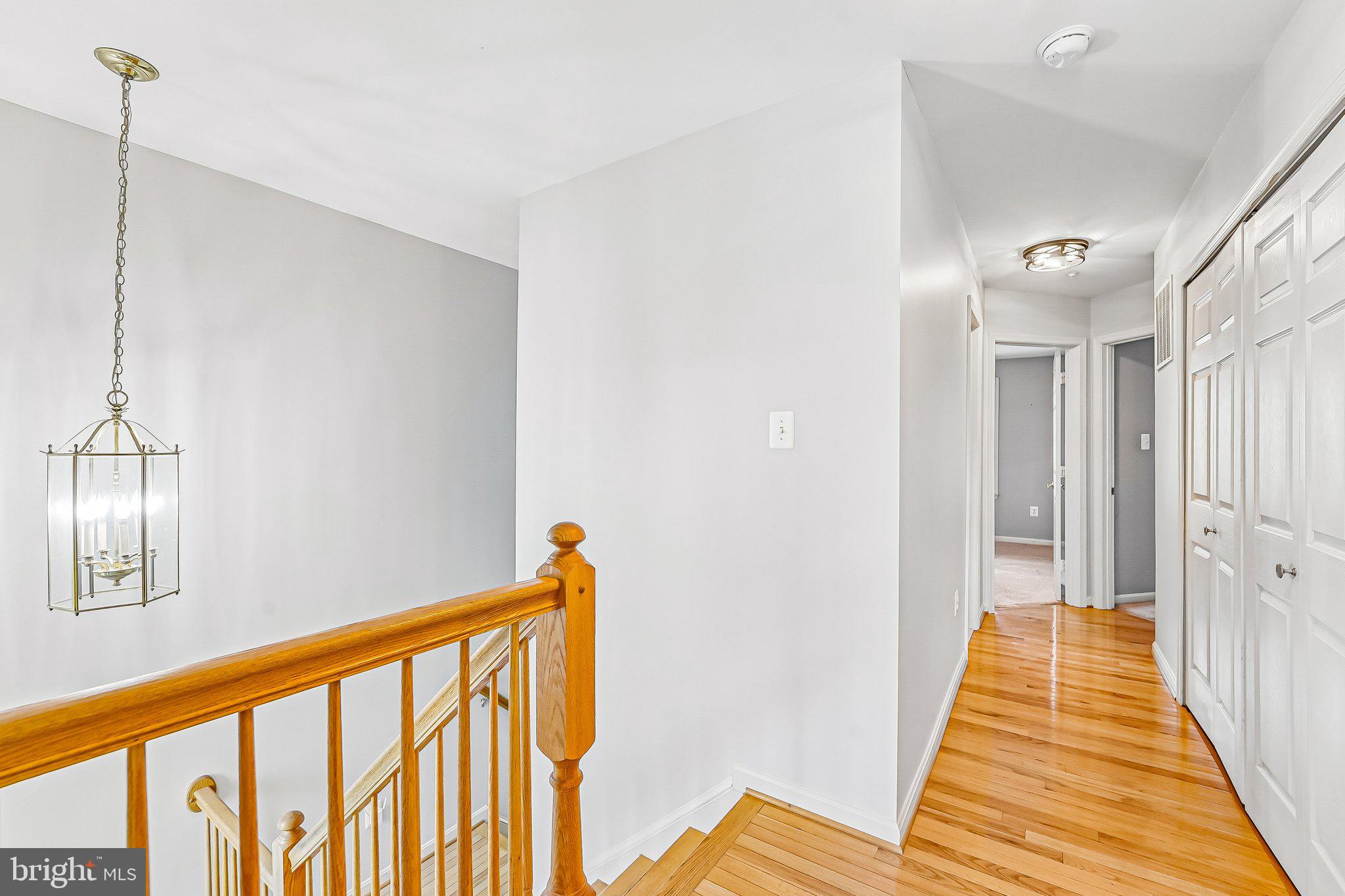 2422 Rippling Brook Road Frederick, MD 21701 - Photo 15 of 35 a view of a hallway with wooden floor and staircase