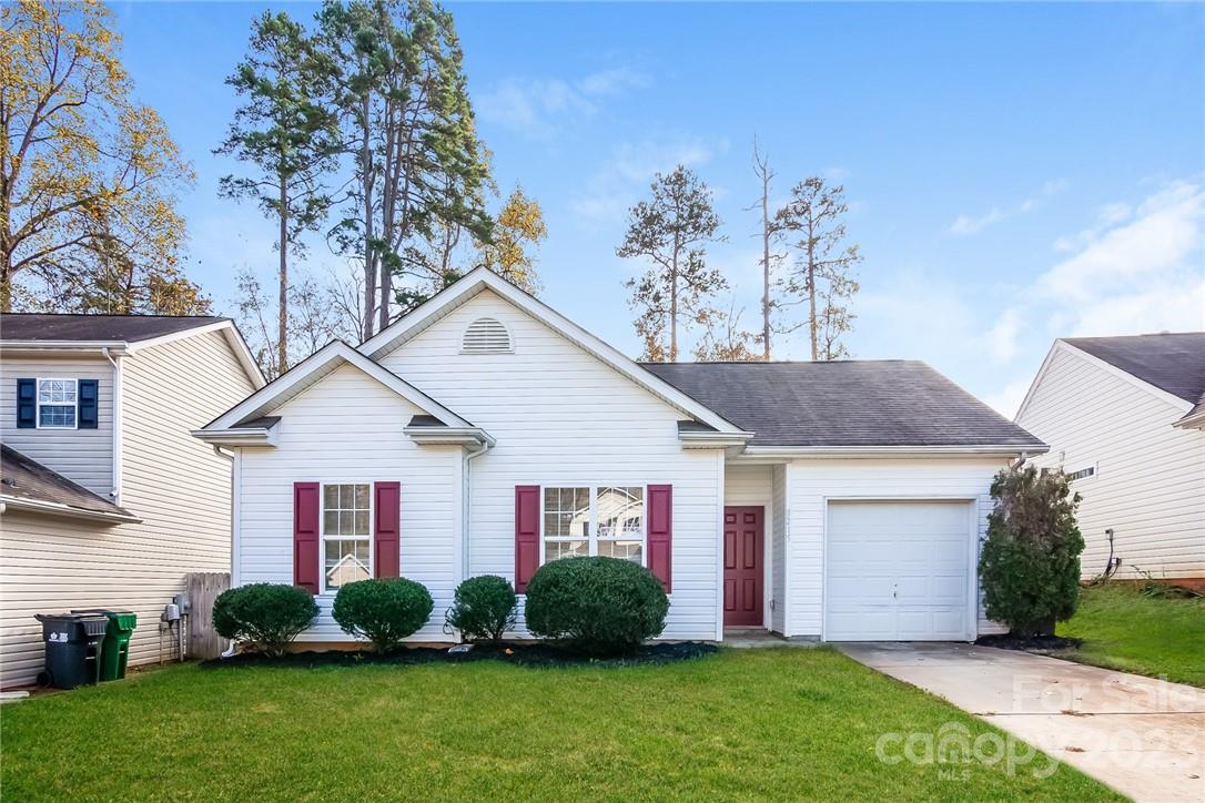 8215 Pozzi Road Charlotte, NC 28216 - Photo 1 of 15 a front view of a house with a garden