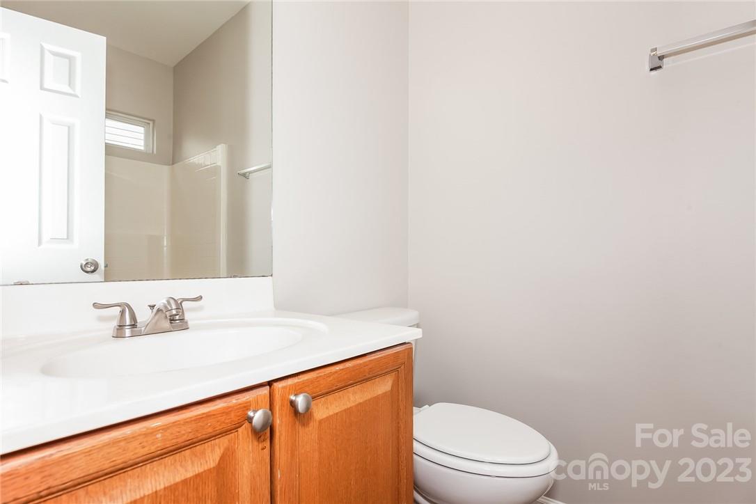 8215 Pozzi Road Charlotte, NC 28216 - Photo 13 of 15 a bathroom with a sink a toilet and a mirror