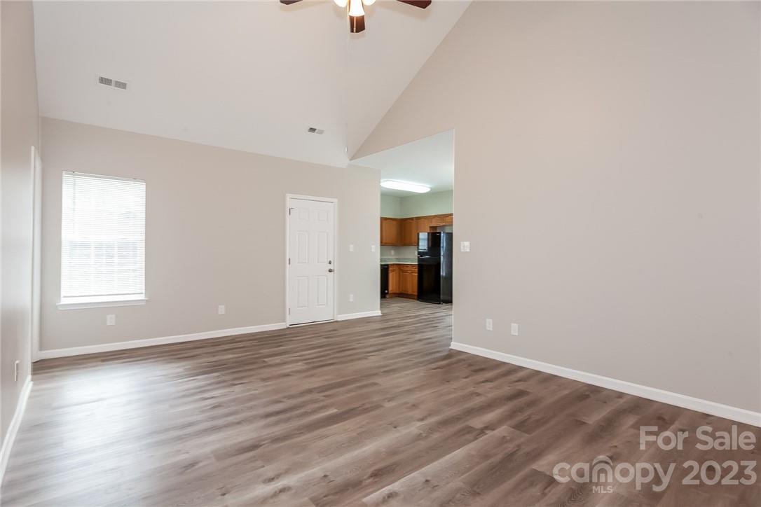 8215 Pozzi Road Charlotte, NC 28216 - Photo 2 of 15 wooden floor in an empty room with a window