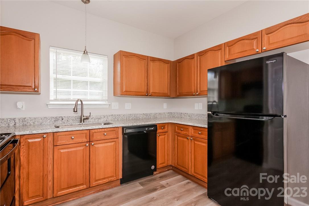 8215 Pozzi Road Charlotte, NC 28216 - Photo 5 of 15 a kitchen with a sink a refrigerator and cabinets