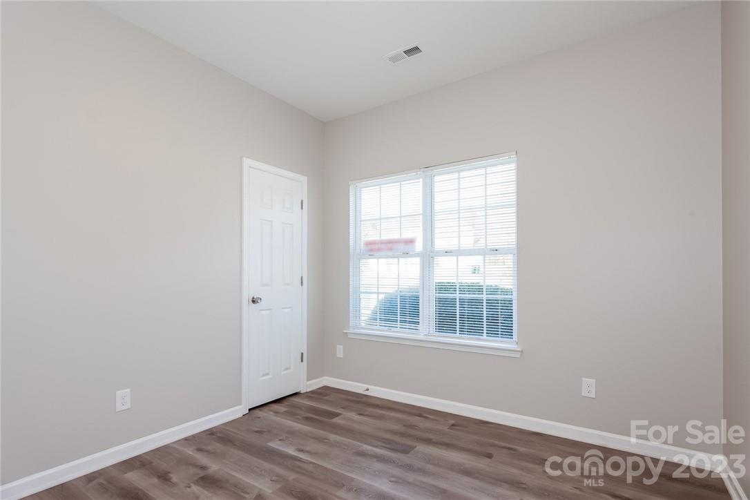 8215 Pozzi Road Charlotte, NC 28216 - Photo 10 of 15 a view of an empty room with wooden floor and a window