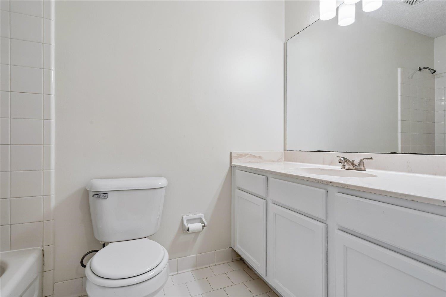 6335 Needle Ridge Road Bartlett, TN 38135 - Photo 20 of 25 Bathroom featuring a single vanity with white cabinetry, light-toned countertop, and an integrated sink