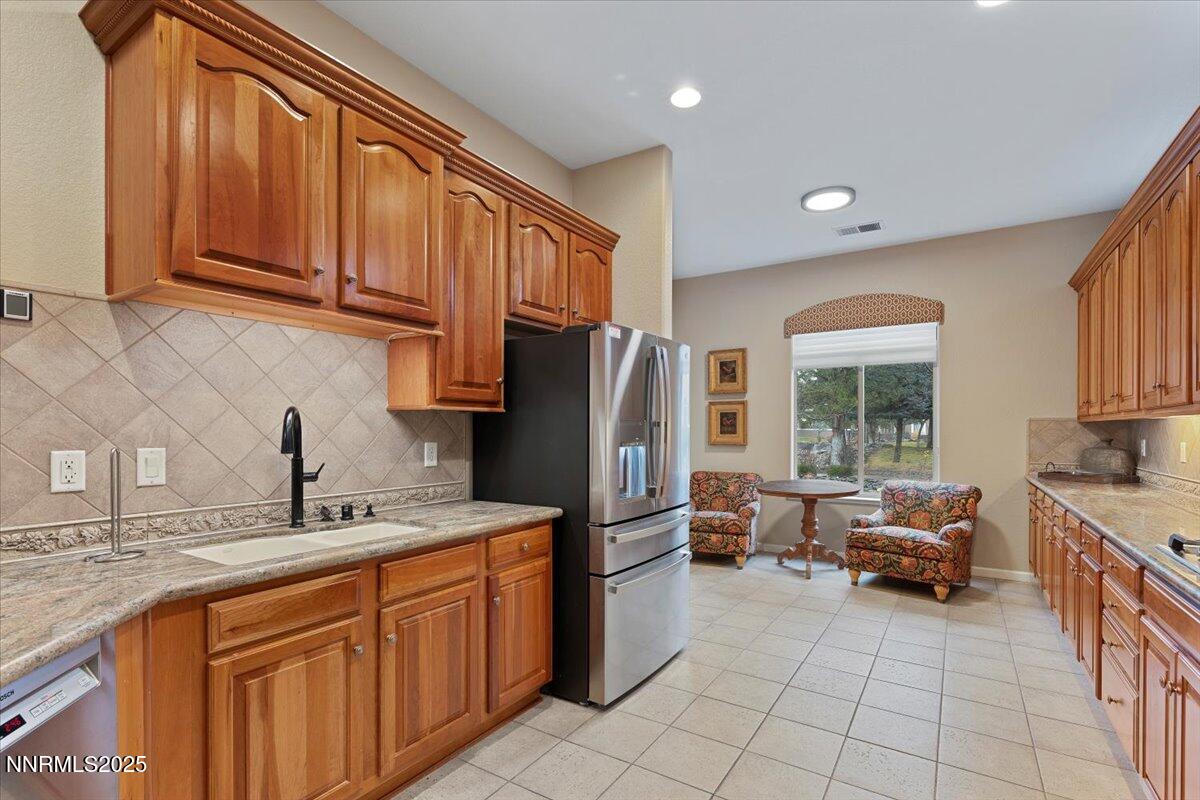 9900 Wilbur May Parkway, Unit 602 Reno, NV 89521 - Photo 11 of 32 a kitchen with stainless steel appliances granite countertop a refrigerator and a sink