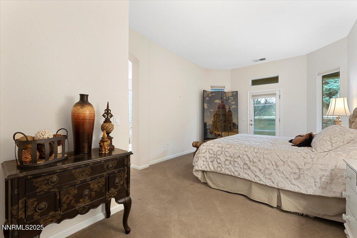 9900 Wilbur May Parkway, Unit 602 Reno, NV 89521 - Photo 19 of 32 a bedroom with a bed and a chair