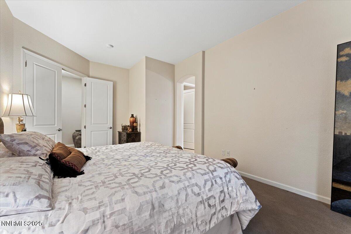 9900 Wilbur May Parkway, Unit 602 Reno, NV 89521 - Photo 21 of 32 a bedroom with a bed and a mirror