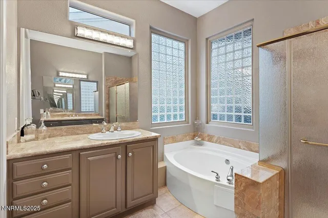 a view of walk in closet with clothes