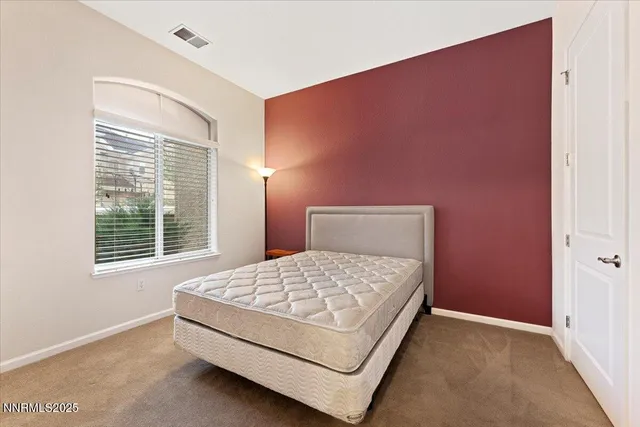 a bedroom with a bed and a bathroom