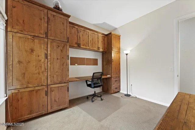 a spacious bathroom with a granite countertop sink toilet mirror and shower