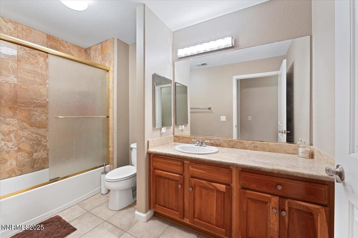 9900 Wilbur May Parkway, Unit 602 Reno, NV 89521 - Photo 30 of 32 a spacious bathroom with a granite countertop sink toilet mirror and shower