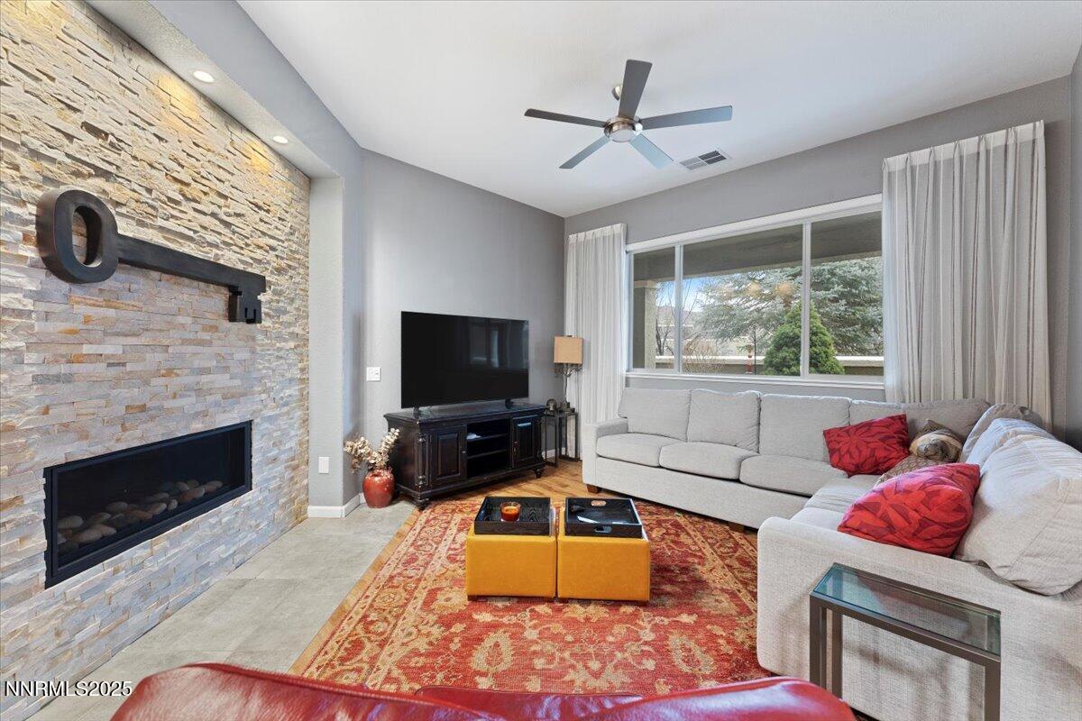 9900 Wilbur May Parkway, Unit 602 Reno, NV 89521 - Photo 6 of 32 a living room with furniture and a flat screen tv