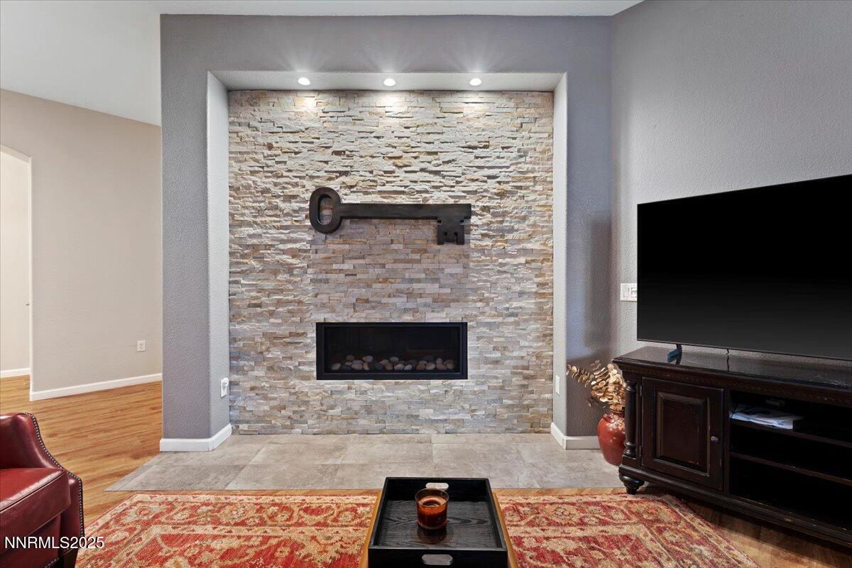 9900 Wilbur May Parkway, Unit 602 Reno, NV 89521 - Photo 7 of 32 a living room with a fireplace and a flat screen tv