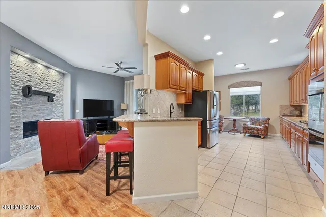 a kitchen with kitchen island granite countertop a sink cabinets and window
