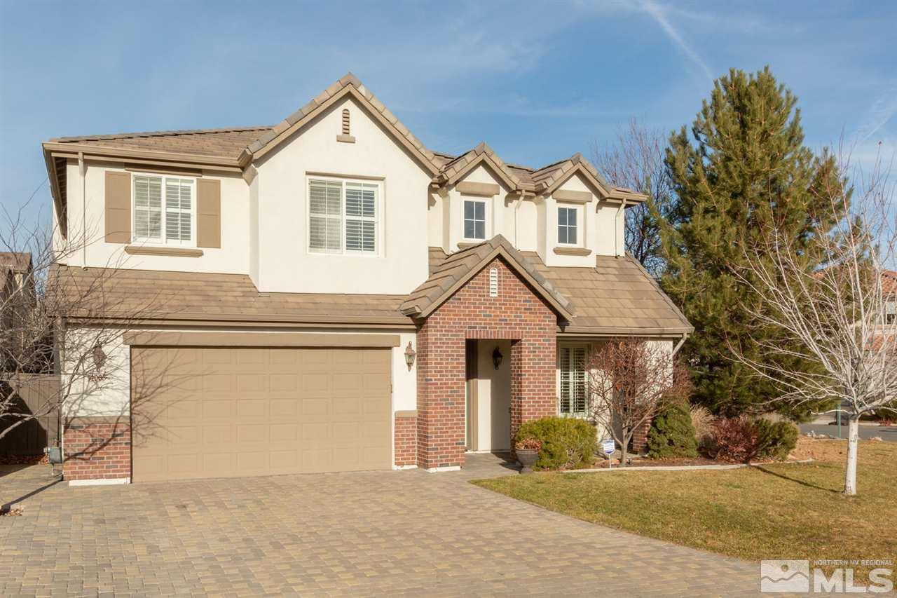 14005 Traveler Court Reno, NV 89521 - Photo 1 of 25 a front view of a house with a yard and garage