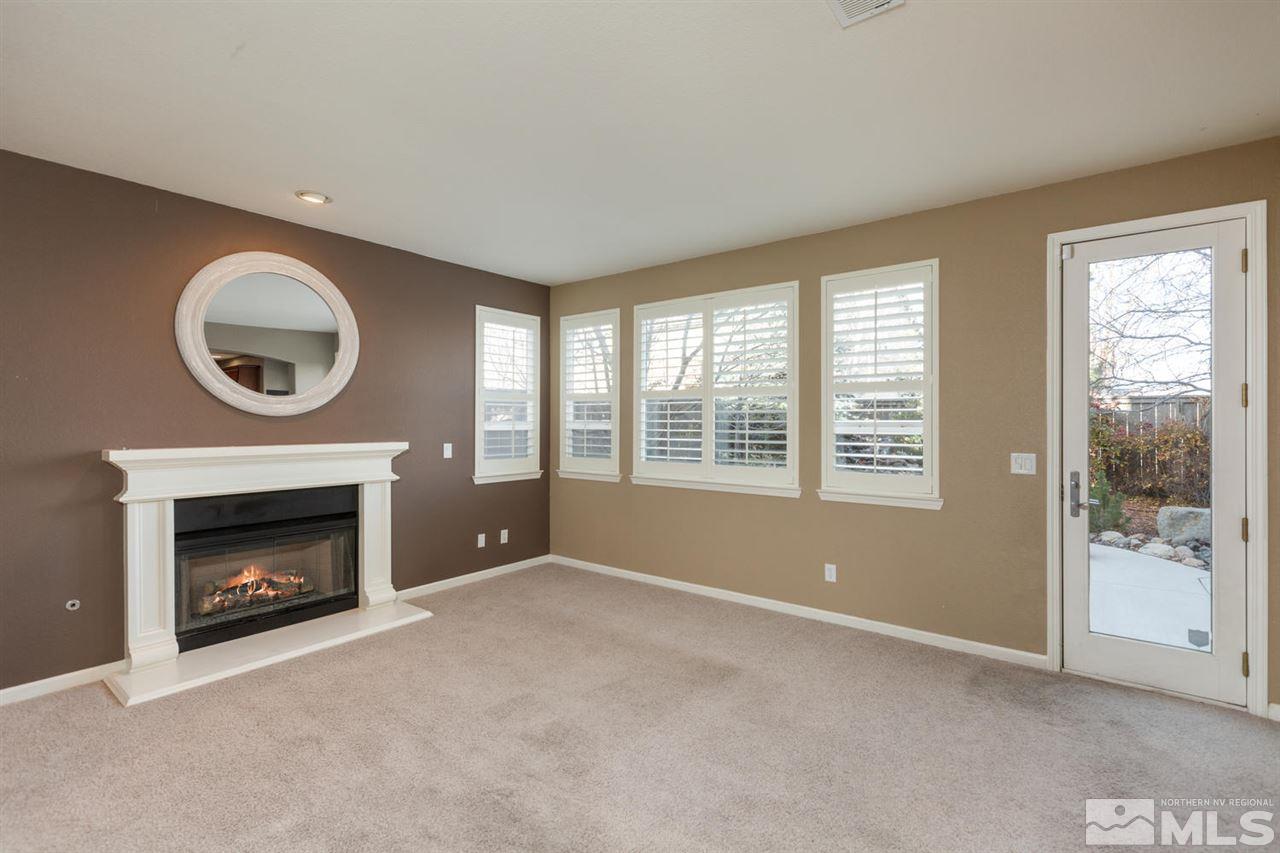 14005 Traveler Court Reno, NV 89521 - Photo 12 of 25 a view of an empty room with a fireplace and a window