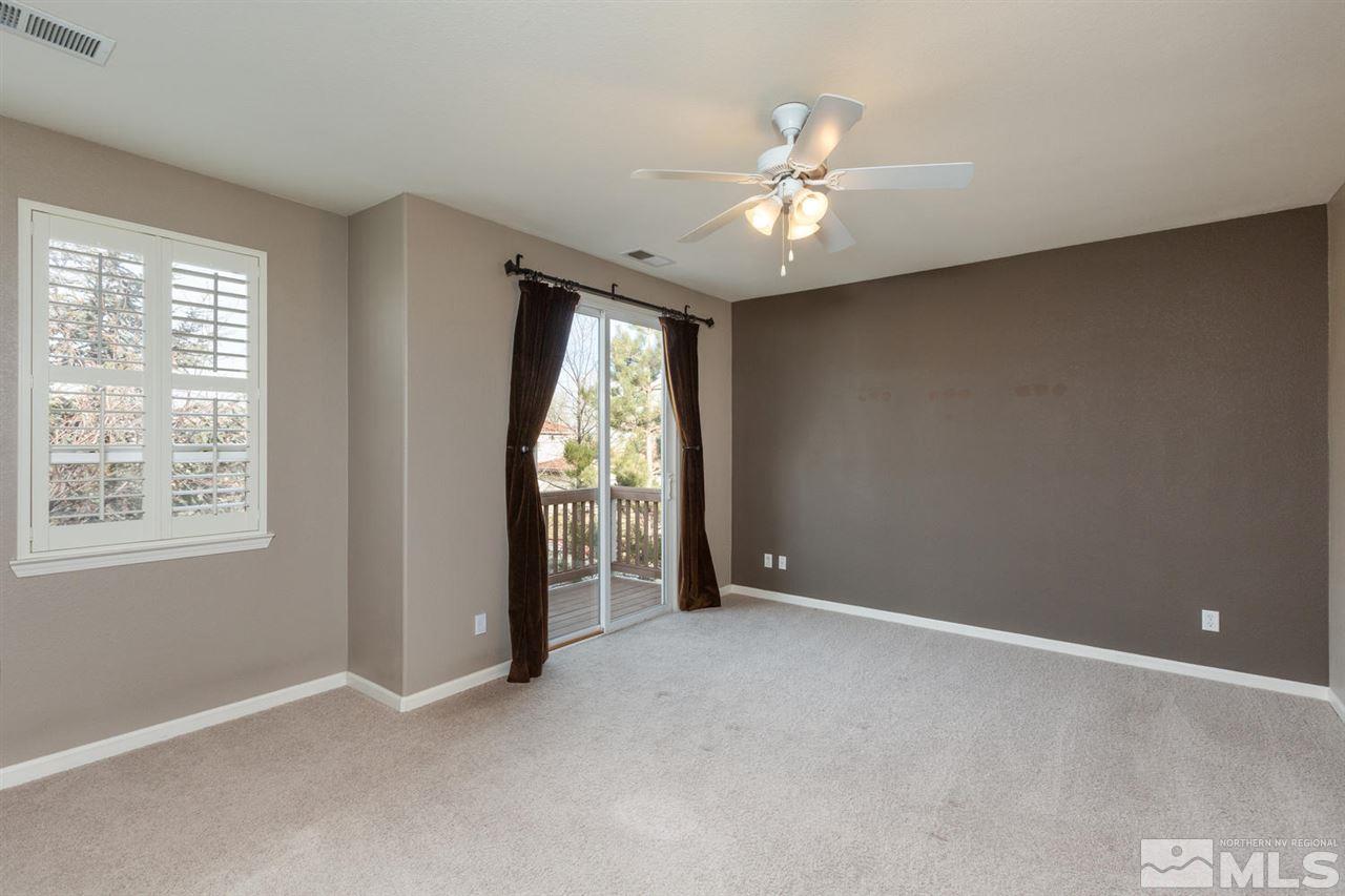 14005 Traveler Court Reno, NV 89521 - Photo 13 of 25 an empty room with windows and chandelier fan