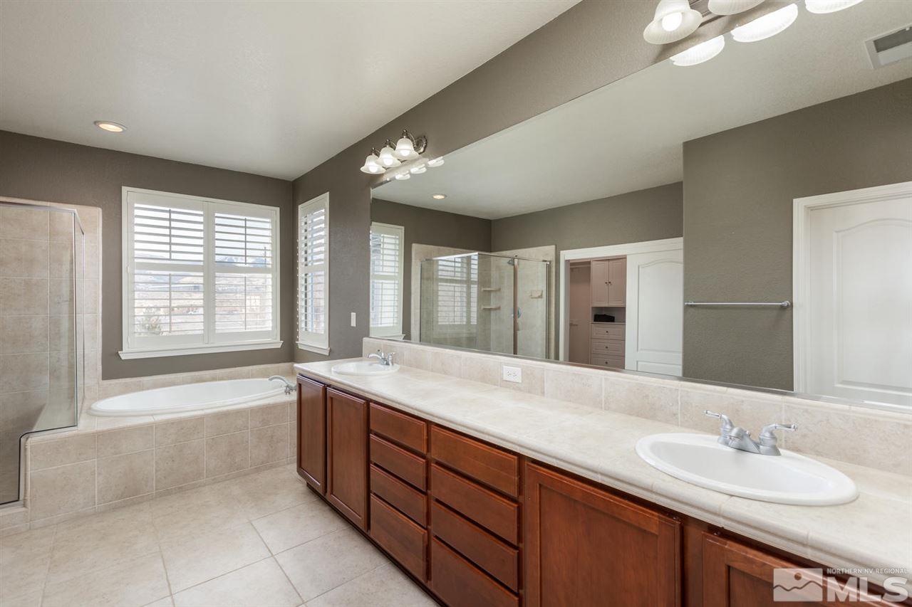 14005 Traveler Court Reno, NV 89521 - Photo 15 of 25 a spacious bathroom with a granite countertop tub sink and mirror