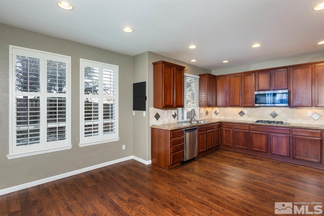 14005 Traveler Court Reno, NV 89521 - Photo 5 of 25 a kitchen with stainless steel appliances granite countertop a stove a sink and a refrigerator