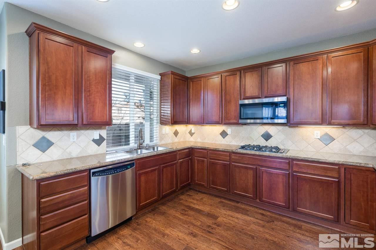 14005 Traveler Court Reno, NV 89521 - Photo 7 of 25 a kitchen with lots of counter top space sink and cabinets
