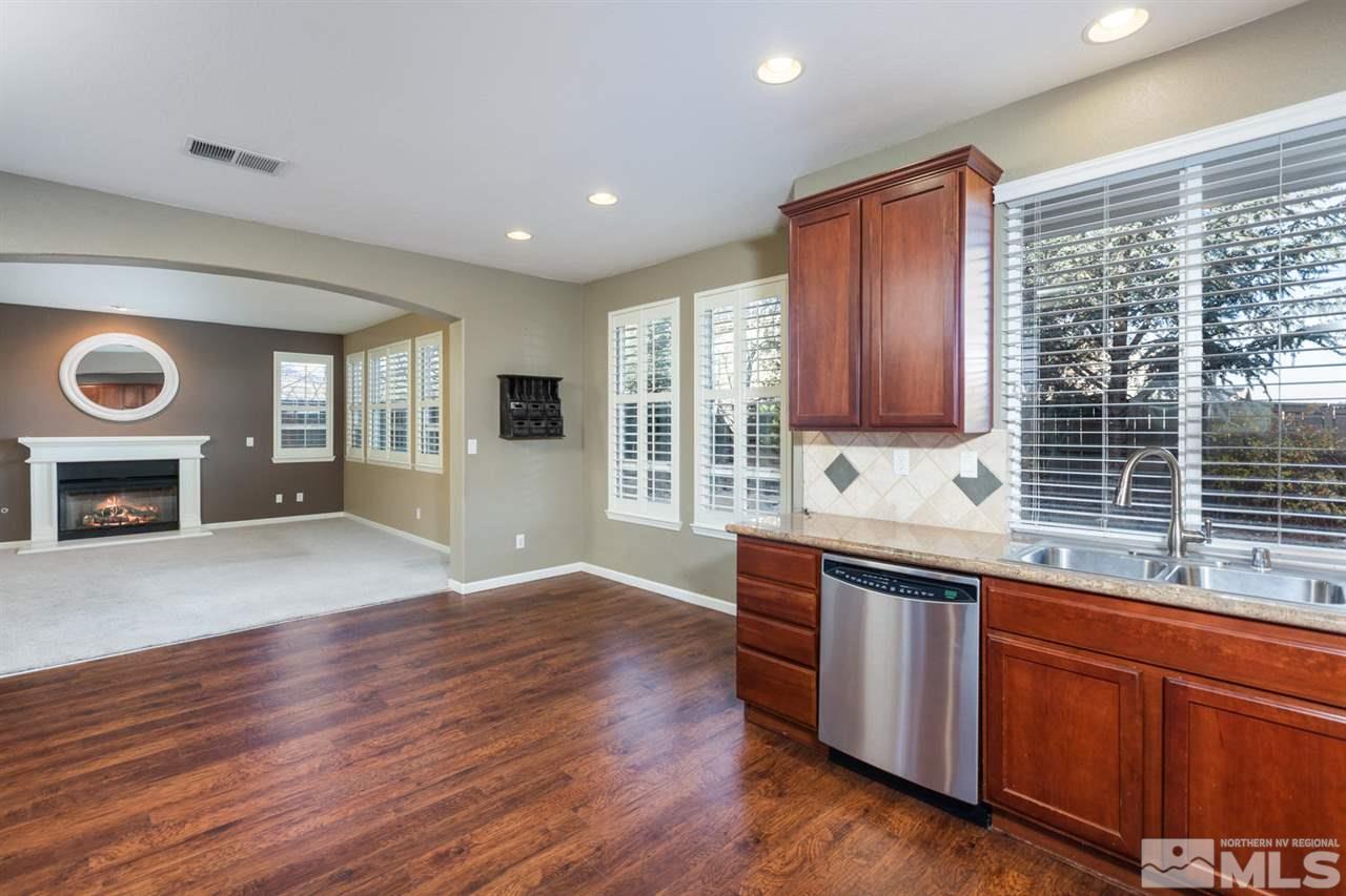 14005 Traveler Court Reno, NV 89521 - Photo 9 of 25 a view of a kitchen with granite countertop cabinets and wooden floor