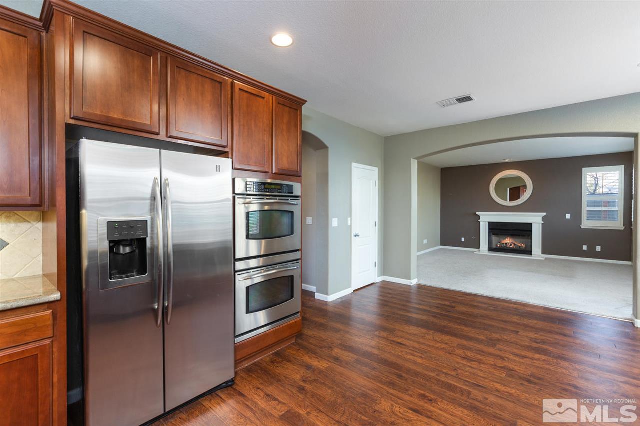 14005 Traveler Court Reno, NV 89521 - Photo 10 of 25 a kitchen with stainless steel appliances granite countertop a refrigerator and a stove