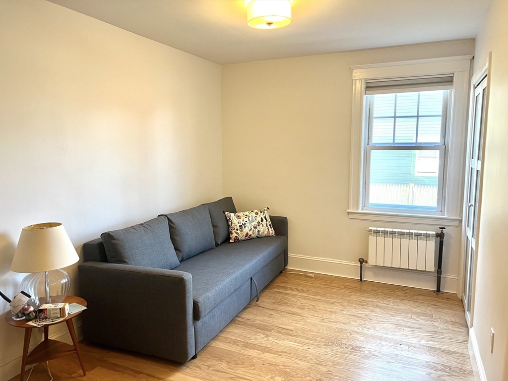 52 Ralph Street, Unit 52 Watertown, MA 02472 - Photo 13 of 17 a living room with furniture and a window
