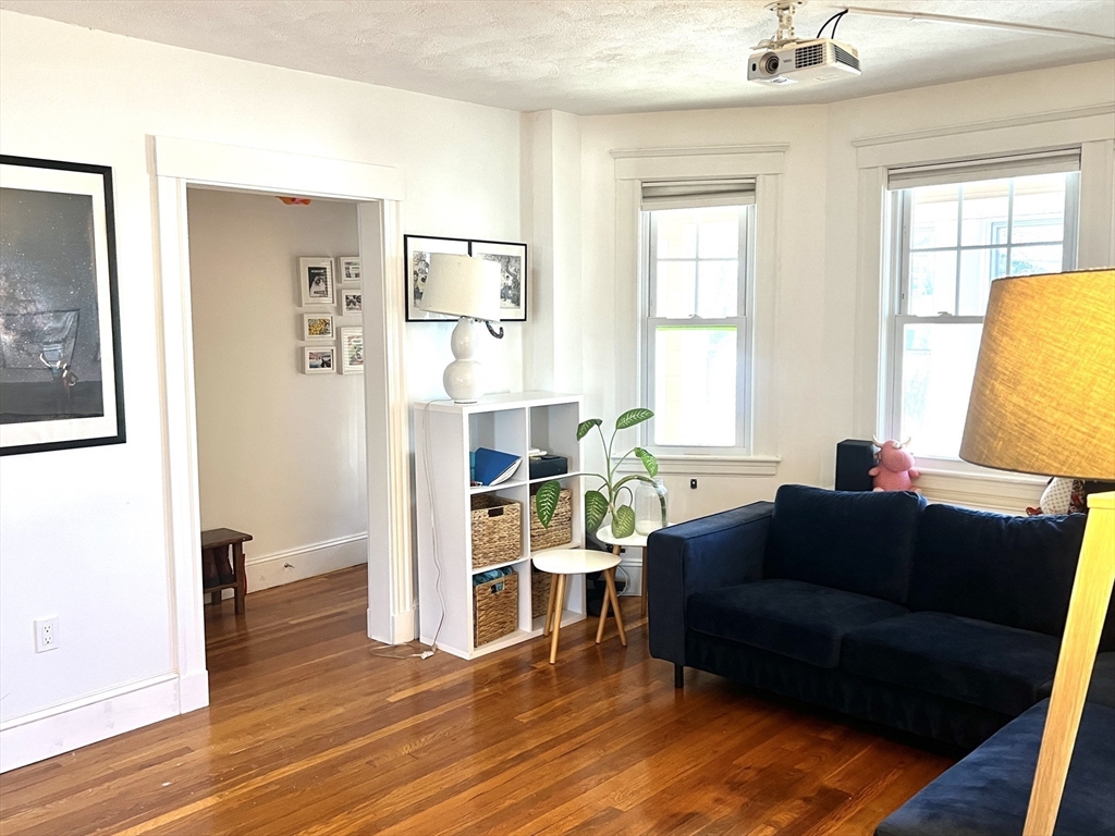 52 Ralph Street, Unit 52 Watertown, MA 02472 - Photo 3 of 17 a living room with furniture and a wooden floor