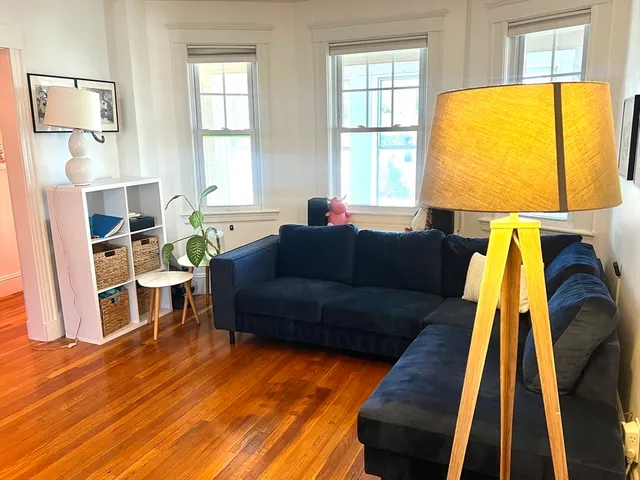 a living room with a couch and wooden floor