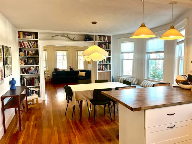 a view of a dining room with furniture and wooden floor