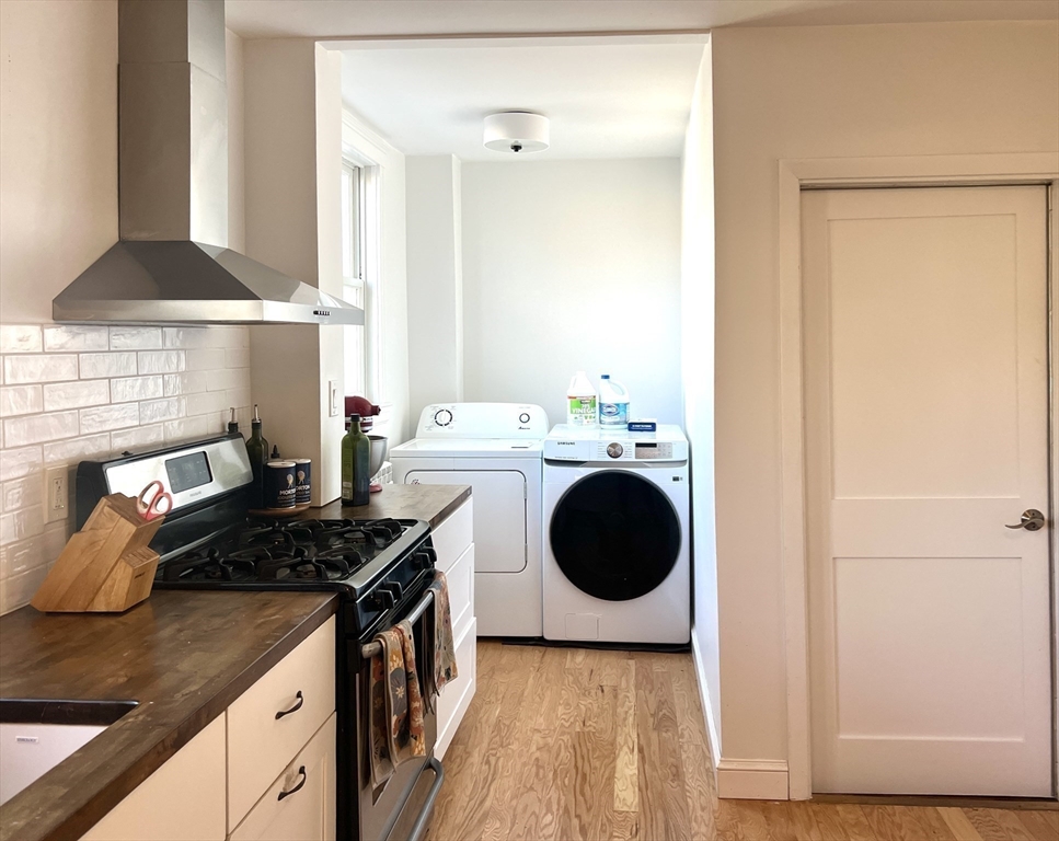 52 Ralph Street, Unit 52 Watertown, MA 02472 - Photo 8 of 17 a kitchen with a stove and a white cabinet