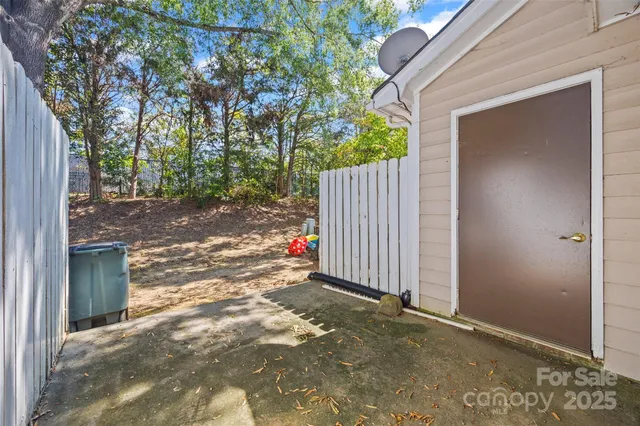 a view of a backyard with wooden fence