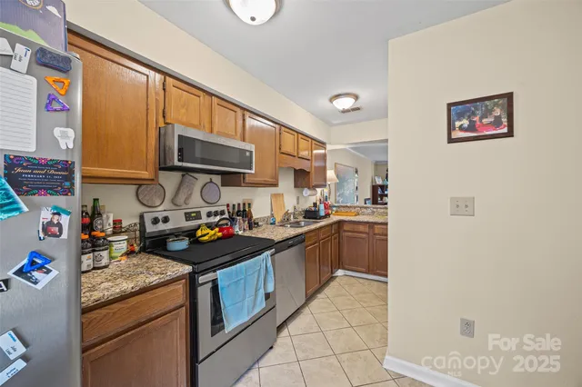 a kitchen with stainless steel appliances granite countertop a stove and a sink