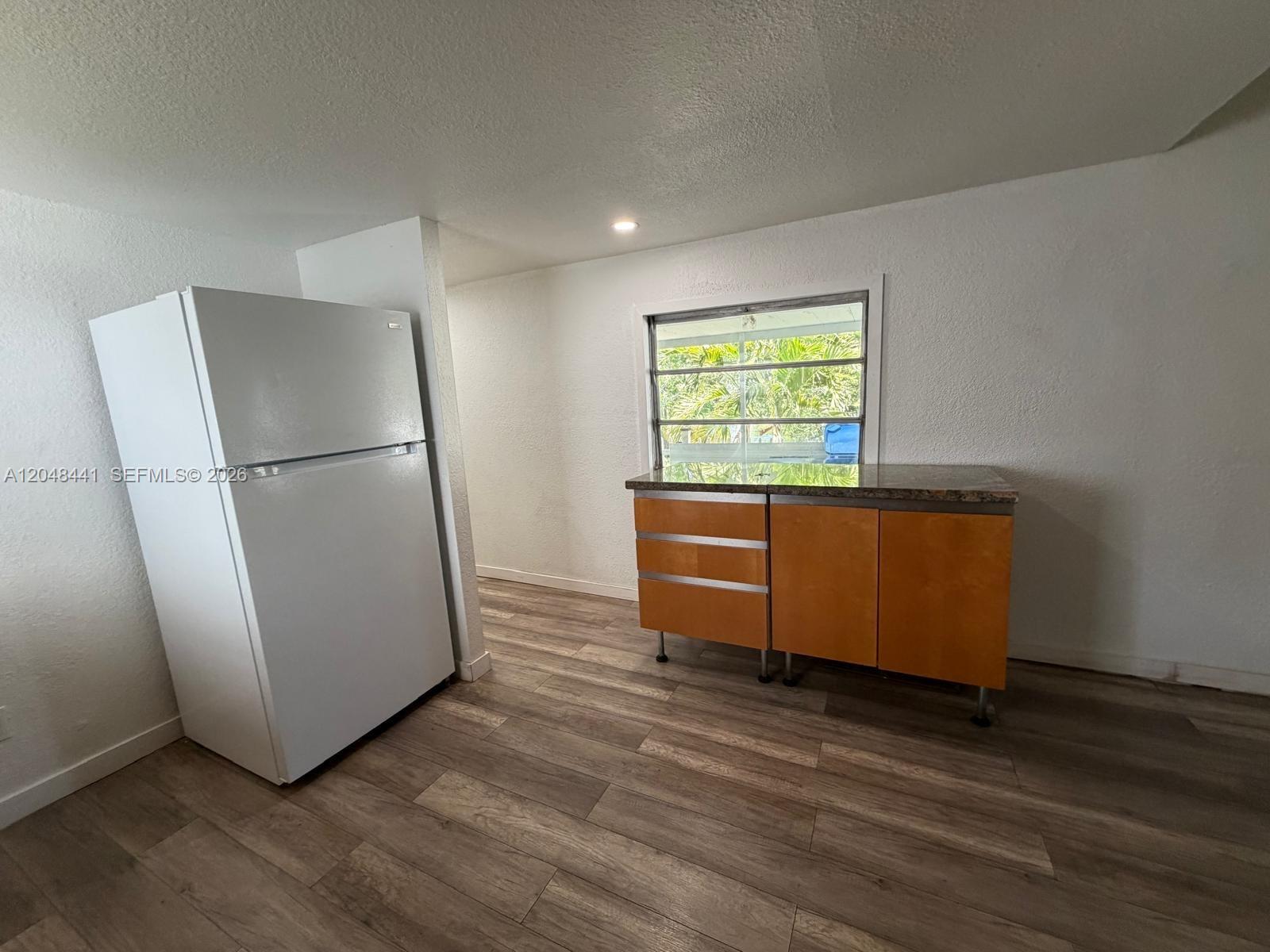 5331 Southwest 35th Street Davie, FL 33314 - Photo 8 of 31 a view of a kitchen with wooden floor and a refrigerator