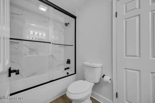 a white toilet sitting next to a bathroom sink