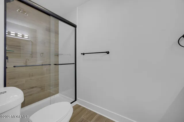 a bathroom with a toilet and a shower