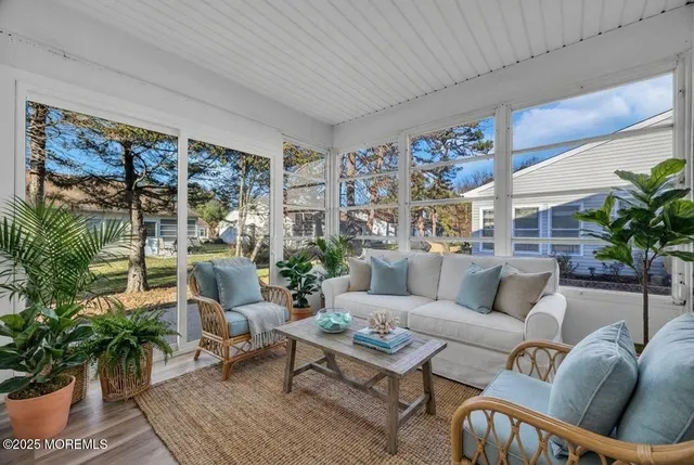 a living room with furniture potted plant and a large window