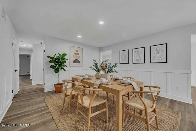 a dining room with furniture and flowers