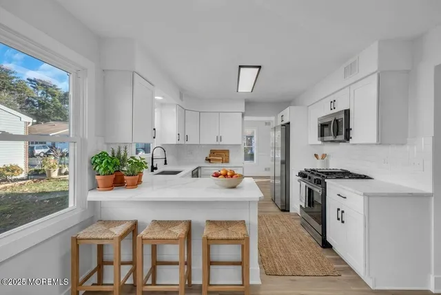 a kitchen with a stove a sink and a refrigerator