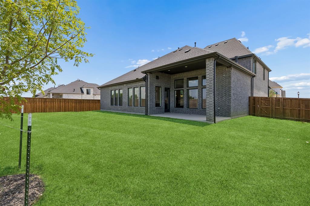 2540 Harpole Road Prosper, TX 75078 - Photo 18 of 19 Offering a large fenced yard with covered back patio, everyone can enjoy the great outdoors in this amazing home!