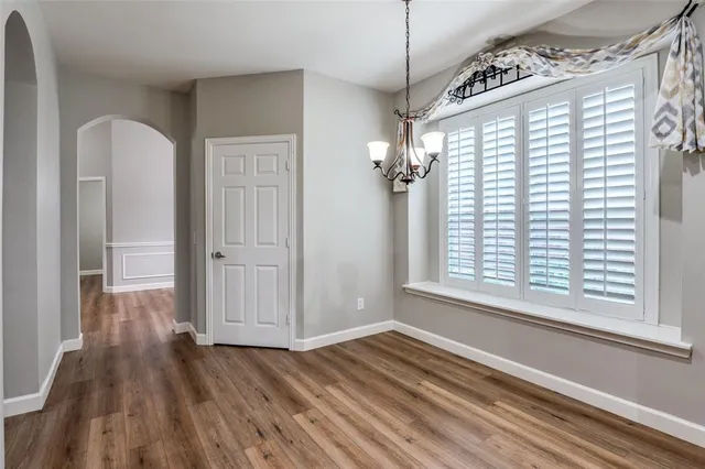 a view of a livingroom with wooden floor and a window