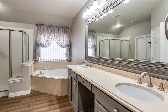 a bathroom with a granite countertop sink and a large mirror