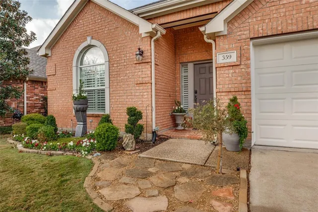 a view of a house with potted plants