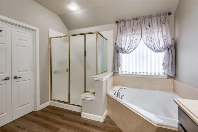 a bathroom with a bathtub and a shower